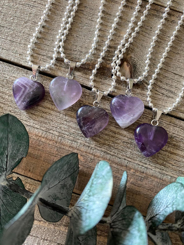 Elevate your style and embrace the soothing energy of our Amethyst Crystal Heart Necklace. This necklace radiates tranquility, spiritual growth, and emotional healing. Amethyst, known as the 'Stone of Spiritual Wisdom,' activates the Crown chakra, deepening your connection to higher realms and enhancing intuition.