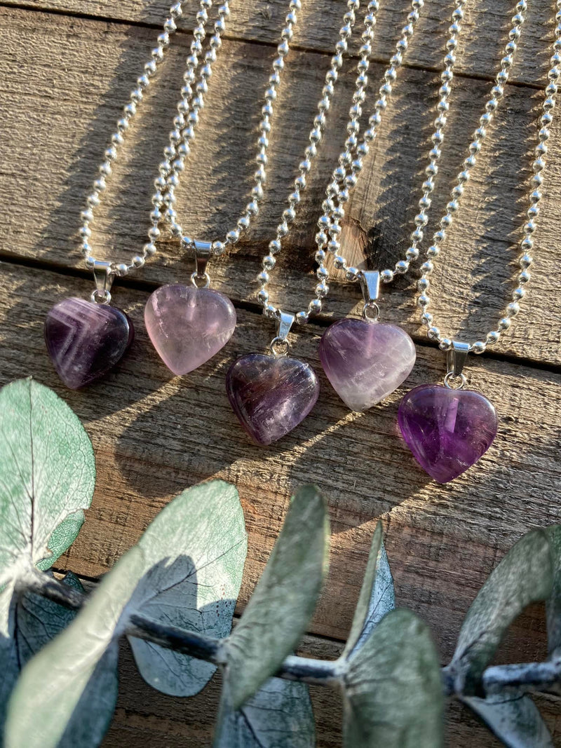 Elevate your style and embrace the soothing energy of our Amethyst Crystal Heart Necklace. This necklace radiates tranquility, spiritual growth, and emotional healing. Amethyst, known as the 'Stone of Spiritual Wisdom,' activates the Crown chakra, deepening your connection to higher realms and enhancing intuition.