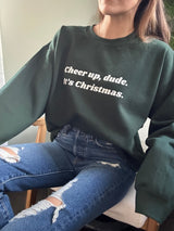 Elevate your holiday spirit with our "Cheer Up, Dude" Sweatshirt. This cozy essential features a fuzzy soft interior that's perfect for staying warm and comfortable during the festive season. With unisex sizing and ribbed knit details, it's a versatile and stylish addition to your winter wardrobe. Spread cheer and laughter with a touch of holiday humor – 'tis the season to be jolly, after all. Get ready to embrace the joy and stay toasty in style with this must-have sweatshirt.