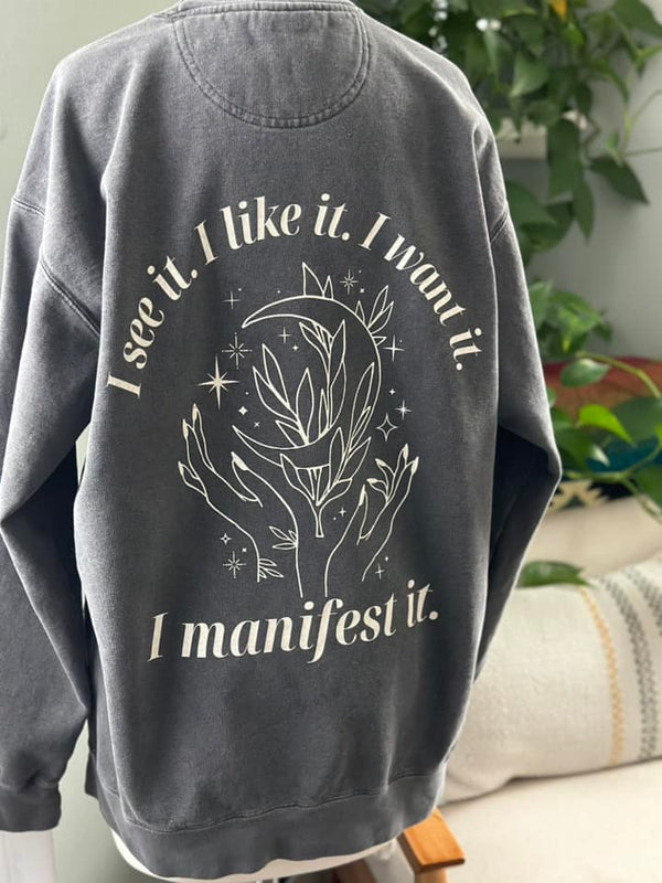 Introducing our "I Manifest It" sweatshirt – where cosmic dreams meet cozy comfort! 🌙✨ Let the world know your mantra: "I see it. I like it. I want it. I manifest it." Embrace the magic, wear your aspirations, and manifest your dreams in style! 🌌💫