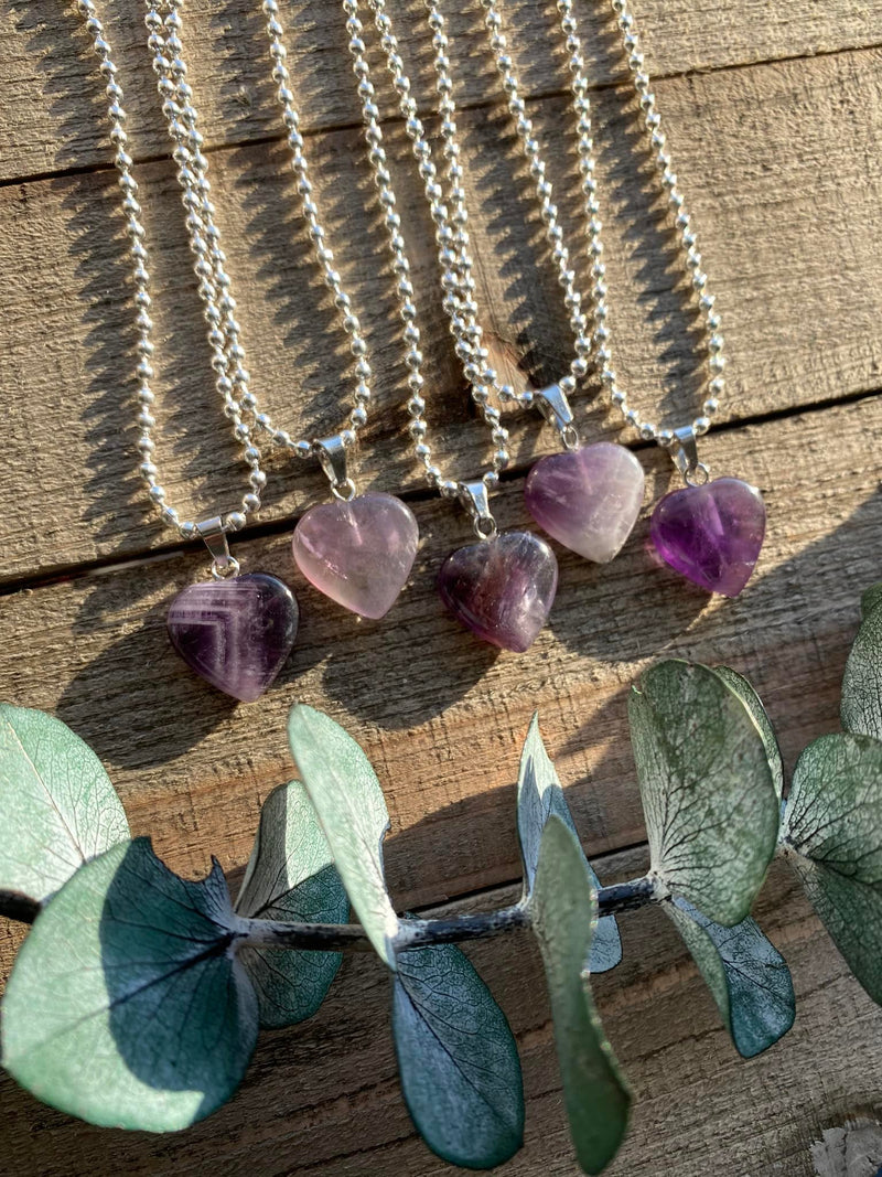 Elevate your style and embrace the soothing energy of our Amethyst Crystal Heart Necklace. This necklace radiates tranquility, spiritual growth, and emotional healing. Amethyst, known as the 'Stone of Spiritual Wisdom,' activates the Crown chakra, deepening your connection to higher realms and enhancing intuition.