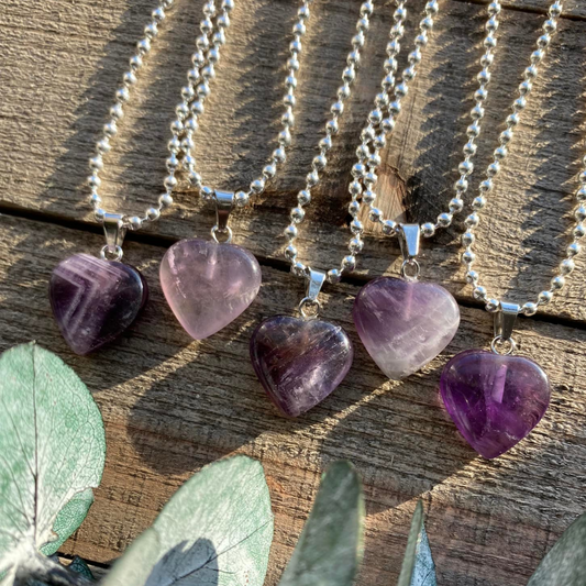 Elevate your style and embrace the soothing energy of our Amethyst Crystal Heart Necklace. This necklace radiates tranquility, spiritual growth, and emotional healing. Amethyst, known as the 'Stone of Spiritual Wisdom,' activates the Crown chakra, deepening your connection to higher realms and enhancing intuition.