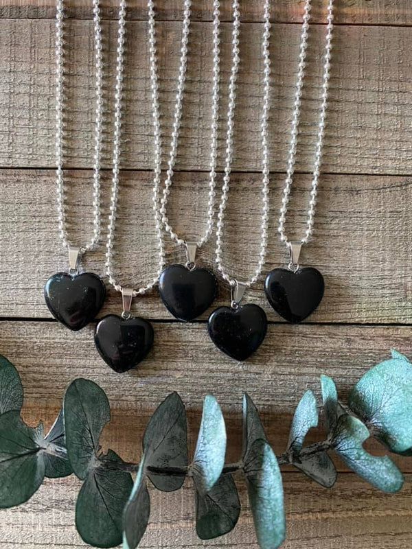 Elevate your style and embrace the protective energy of our Black Obsidian Crystal Heart Necklace. This necklace radiates strength, grounding, and spiritual purification. Black Obsidian, known as the 'Stone of Protection,' shields against negativity, absorbs unwanted energies, and promotes emotional healing. 