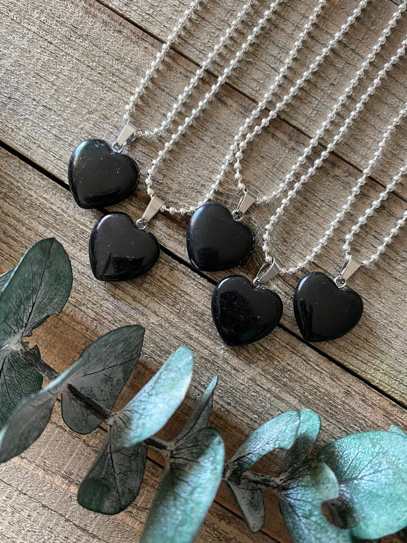 Elevate your style and embrace the protective energy of our Black Obsidian Crystal Heart Necklace. This necklace radiates strength, grounding, and spiritual purification. Black Obsidian, known as the 'Stone of Protection,' shields against negativity, absorbs unwanted energies, and promotes emotional healing. 