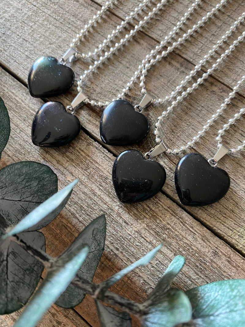 Elevate your style and embrace the protective energy of our Black Obsidian Crystal Heart Necklace. This necklace radiates strength, grounding, and spiritual purification. Black Obsidian, known as the 'Stone of Protection,' shields against negativity, absorbs unwanted energies, and promotes emotional healing. 