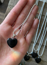 Elevate your style and embrace the protective energy of our Black Obsidian Crystal Heart Necklace. This necklace radiates strength, grounding, and spiritual purification. Black Obsidian, known as the 'Stone of Protection,' shields against negativity, absorbs unwanted energies, and promotes emotional healing. 