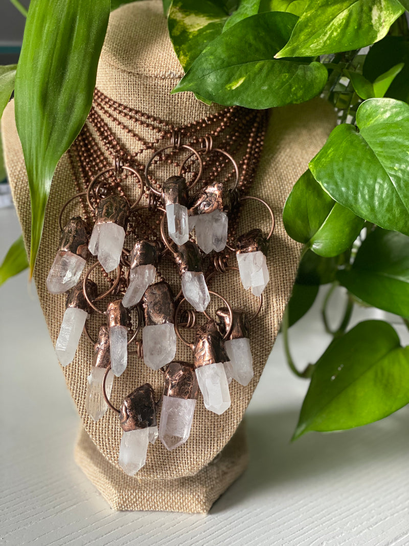 Experience the pure radiance of our electroformed clear quartz crystal necklace. Meticulously crafted, this captivating piece showcases the pristine beauty and metaphysical properties of clear quartz. Revel in the luminous clarity and amplifying energy of this remarkable crystal, as it graces your neckline with timeless elegance.