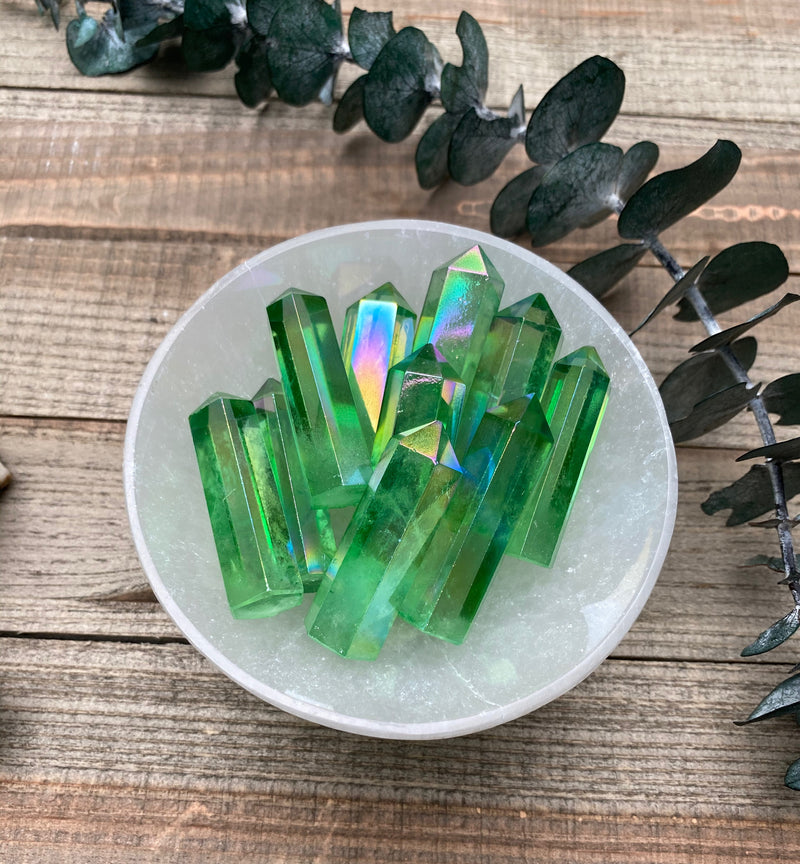 Green Aura Quartz is a crystal that holds a profound connection to the metaphysical realm, offering a multitude of transformative and healing properties. With its vibrant green hue, it resonates strongly with the heart chakra, facilitating the balance and alignment of emotions, love, and compassion. This crystal is known for its ability to open up one's heart to universal love, promoting self-acceptance, forgiveness, and inner peace.