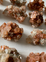 Discover the grounding and harmonizing power of raw Aragonite stones. These captivating gemstones, with their natural formations and earthy hues, offer a sense of calm and stability in your life. Embrace their metaphysical properties and experience a deep connection with the Earth's energies, fostering balance and tranquility. 