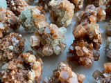 Discover the grounding and harmonizing power of raw Aragonite stones. These captivating gemstones, with their natural formations and earthy hues, offer a sense of calm and stability in your life. Embrace their metaphysical properties and experience a deep connection with the Earth's energies, fostering balance and tranquility. 