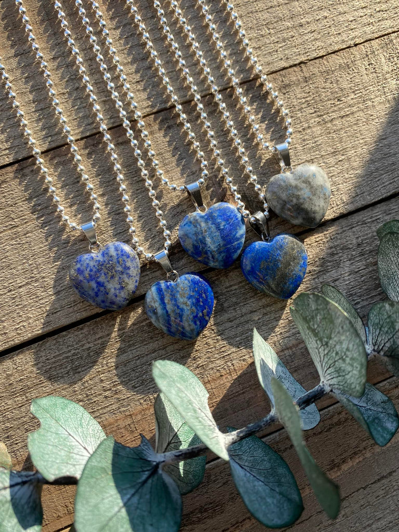 Elevate your style and embrace the majestic energy of our Lapis Lazuli Crystal Heart Necklace. This necklace radiates wisdom, truth, and spiritual enlightenment. Lapis Lazuli, known as the 'Stone of Royalty,' enhances intuition, deepens spiritual connection, and stimulates inner wisdom. 