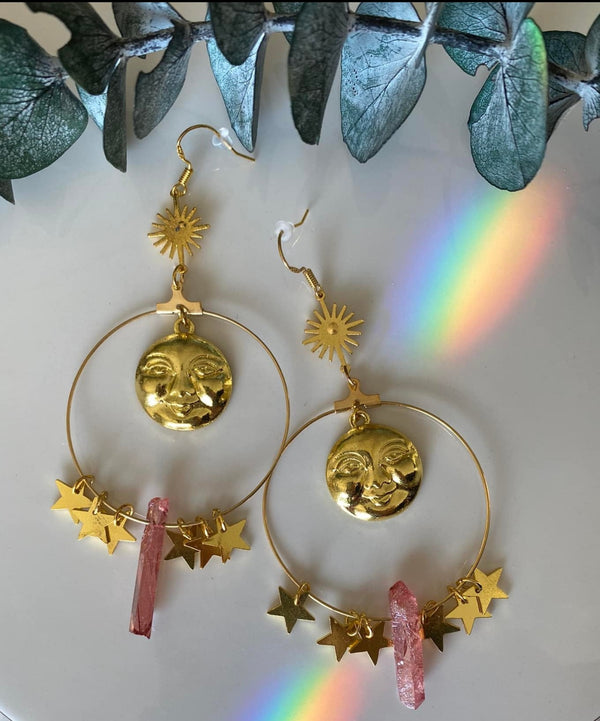 Step into a realm of ethereal beauty with our Pink Aura Quartz Moon Hanging Earrings. These exquisite earrings feature delicate moons and shimmering Pink Aura Quartz, a stone known for its enchanting and soothing energy. 