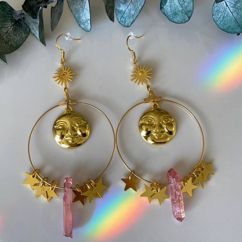 Step into a realm of ethereal beauty with our Pink Aura Quartz Moon Hanging Earrings. These exquisite earrings feature delicate moons and shimmering Pink Aura Quartz, a stone known for its enchanting and soothing energy. 