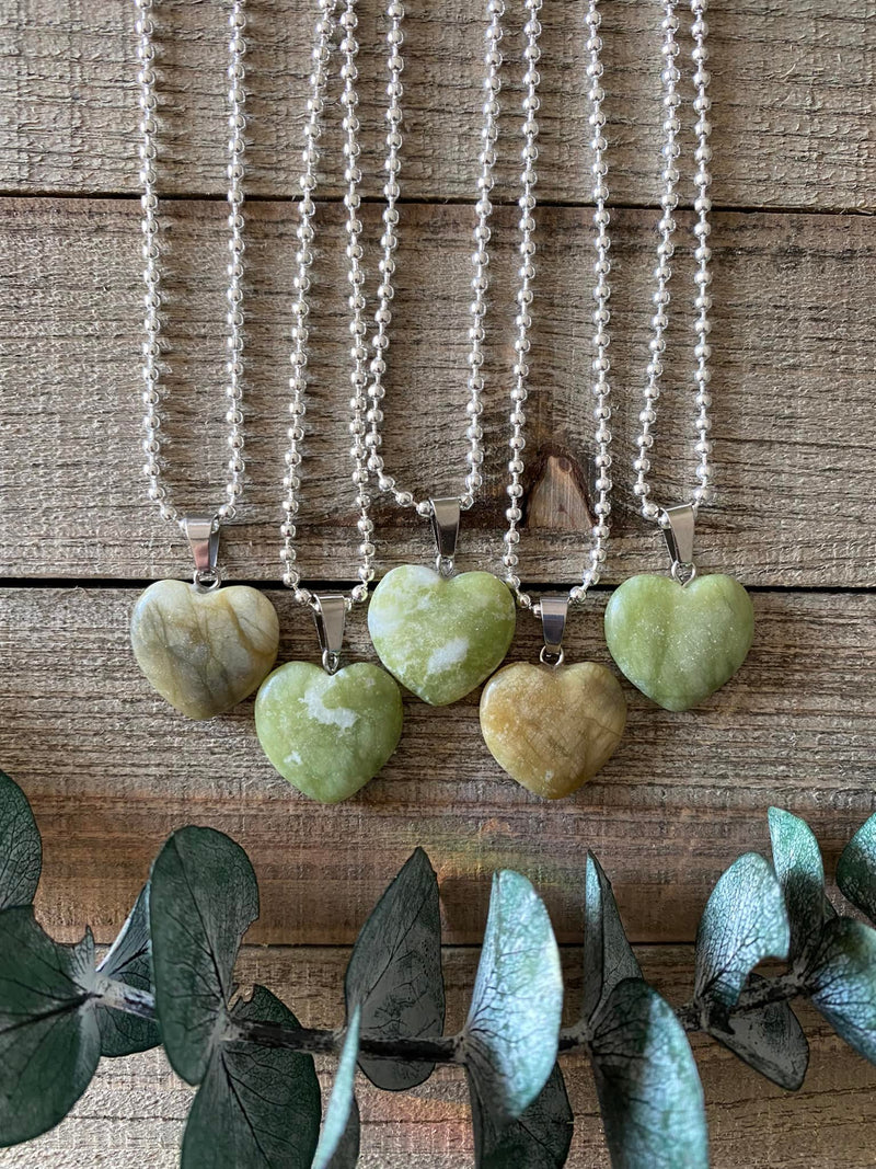 Elevate your style and embrace the healing energy of our Serpentine Crystal Heart Necklace. This necklace radiates rejuvenation, transformation, and spiritual growth. Serpentine, known as the 'Stone of Transformation,' assists in shedding old patterns and embracing positive change. 