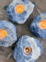 Illuminate your space with the enchanting beauty of Sodalite tea candle holders. These captivating gemstone creations, crafted from the mesmerizing blue hues of Sodalite, infuse your surroundings with a serene and tranquil ambiance. Embrace the metaphysical properties of Sodalite as it promotes peace, harmony, and enhanced communication. 