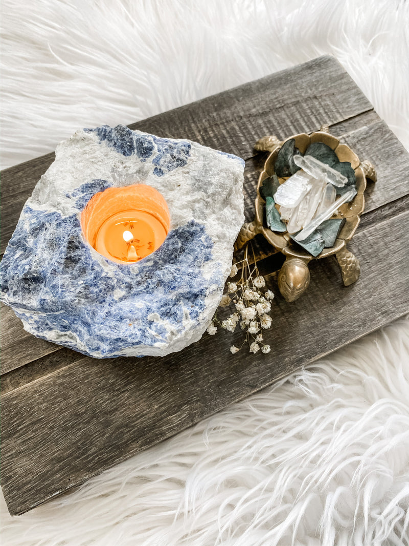 Illuminate your space with the enchanting beauty of Sodalite tea candle holders. These captivating gemstone creations, crafted from the mesmerizing blue hues of Sodalite, infuse your surroundings with a serene and tranquil ambiance. Embrace the metaphysical properties of Sodalite as it promotes peace, harmony, and enhanced communication. 