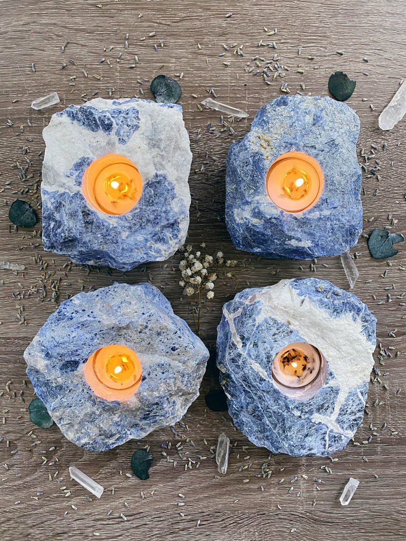 Illuminate your space with the enchanting beauty of Sodalite tea candle holders. These captivating gemstone creations, crafted from the mesmerizing blue hues of Sodalite, infuse your surroundings with a serene and tranquil ambiance. Embrace the metaphysical properties of Sodalite as it promotes peace, harmony, and enhanced communication. 