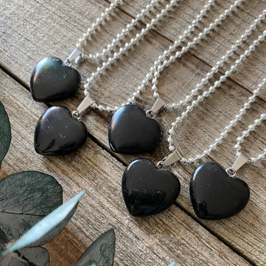 Elevate your style and embrace the protective energy of our Black Obsidian Crystal Heart Necklace. This necklace radiates strength, grounding, and spiritual purification. Black Obsidian, known as the 'Stone of Protection,' shields against negativity, absorbs unwanted energies, and promotes emotional healing. 